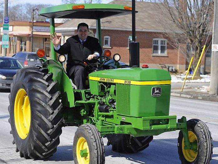 Peterborough MP Dean Del Mastro drives a tractor when announcing plans for a tractor parade to open the 2013 Peterborough Exhibition (photo: deandelmastro.ca)