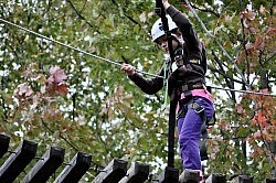 Milli MacDonald navigates the rope course at at the annual James Fund Neuroblastoma Family Retreat (photo courtesy of Janine MacDonald).