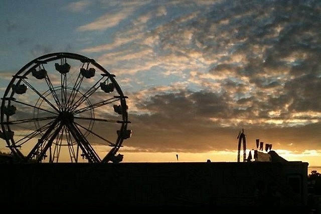 The sun going down on the Lindsay Fair; a few folks still seem to be in the ferris wheel, perhaps enjoying the view (photo: Carol Lawless)