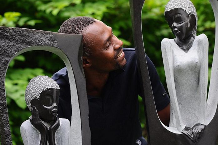 ZimArt's 2014 artist-in-residence Vengai Chiwawa poses with his "Romeo and Juliet". A remarkably similar story to the Shakespeare play is told in Zimbabwe. (Photo: Paul Hodgkinson)