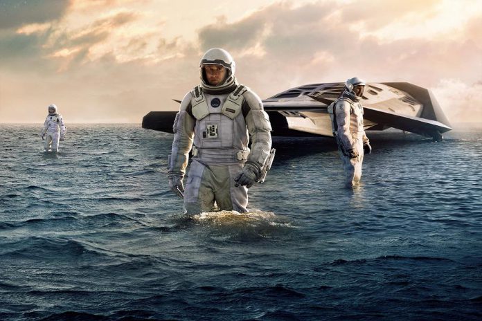 A scene from Interstellar, where the exploratory team lands a water planet whose proximity to a black hole slows down the passage of time