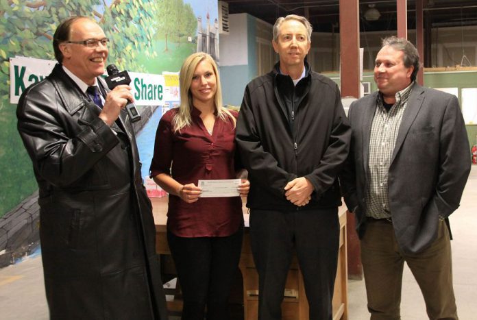 Peterborough Mayor Daryl Bennett presents a cheque for $11,594.45 to Ashlee Aitken of Kawartha Food Share. The money was raised during the free two-hour parking promotion in downtown Peterborough during December. Also pictured is Dennis Van Amerongen, Parking Operations Coordinator with the City, and Terry Guiel, Executive Director of the Peterborough DBIA. (Photo: Jeannine Taylor / kawarthaNOW)