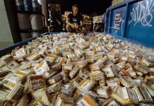 Grant Baldwin, director and editor of the film "Just Eat It", kneels over a dumpster filled with discarded hummus. The film explores food waste, as Grant and his wife Jen attempt to live off of nothing but discarded food for six months. The film will be shown on Saturday, January 24 at Showplace in Peterborough as part of ReFrame Film Festival.