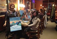 Elaine DeCunha, owner of the Millbrook-based company Spirits and Splatters, guides a group of enthusiastic painters at an event at Boston Pizza Lindsay in January 2015. The company is offering more creative and fun social events in February and March in Peterborough and Lindsay.