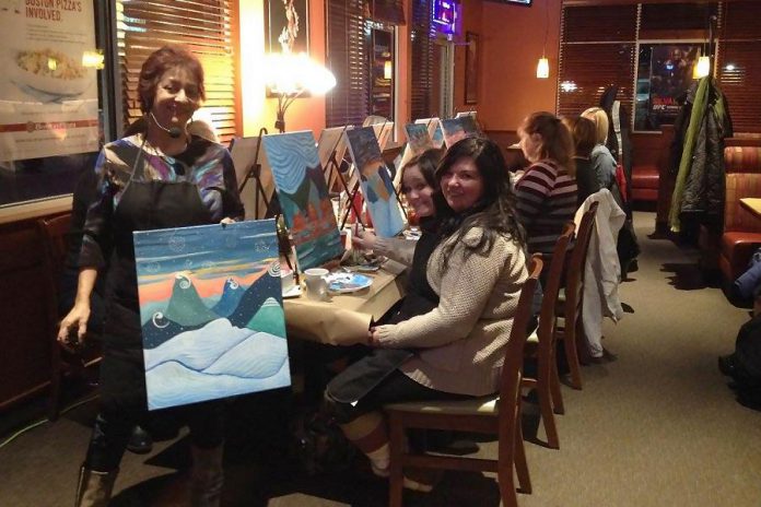 Elaine DeCunha, owner of the Millbrook-based company Spirits and Splatters, guides a group of enthusiastic painters at an event at Boston Pizza Lindsay in January 2015. The company is offering more creative and fun social events in February and March in Peterborough and Lindsay.