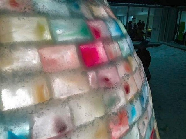 The beautiful colours of the ice bricks glowing at night when the igloo is lit from inside