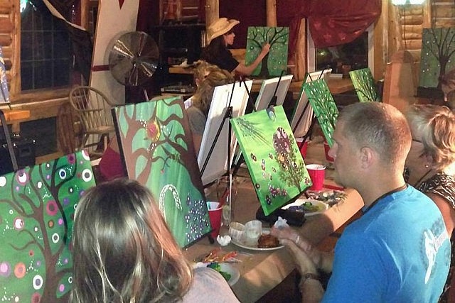 Participants complete their paintings at an event at Mark's Finer Diner in Peterborough in July 2014. In addition to the social aspect, the experience of painting can be therapeutic.