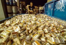 Grant Baldwin, producer of the film "Just Eat It" that focuses on the topic of food waste, kneels over a dumpster of discarded hummus. Food waste in Canada is valued at a staggering $31 billion in 2014, up 15% from 2013.