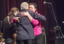 Jeannine Taylor, one of "The Friends of Al Black" who organized the event, embraces him at the end of the seven-hour concert. Proceeds from the event will go into a trust fund for Al's granddaughter Lydia, to support family costs while Lydia receives treatment in Toronto for a blood disease rarely found in children. (Photo: Linda McIlwain / kawarthaNOW)