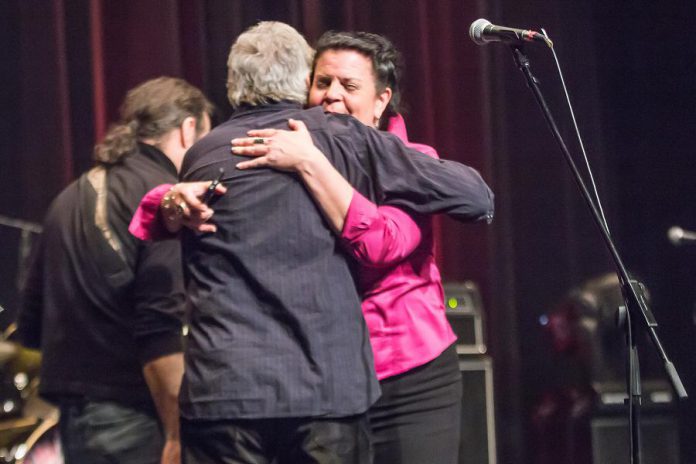 Jeannine Taylor, one of "The Friends of Al Black" who organized the event, embraces him at the end of the seven-hour concert. Proceeds from the event will go into a trust fund for Al's granddaughter Lydia, to support family costs while Lydia receives treatment in Toronto for a blood disease rarely found in children. (Photo: Linda McIlwain / kawarthaNOW)