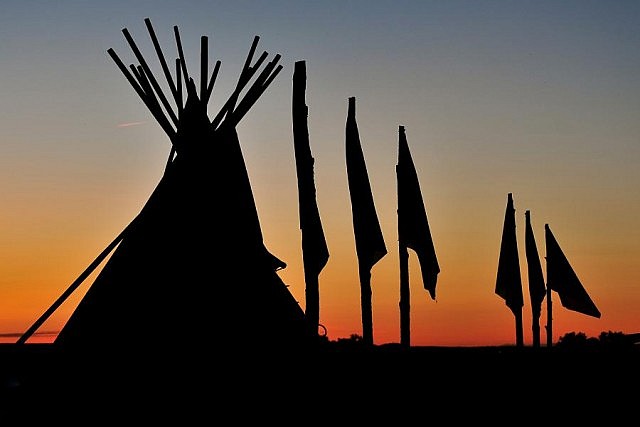 This tipi with flag poles is from Pine Ridge Reservation in South Dakota (photo: George Campana)