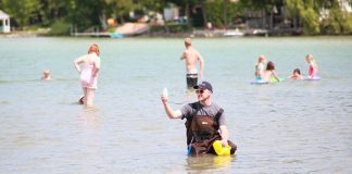 Taking a sample of water at a local beach for testing. (Photo: Peterborough Public Health)