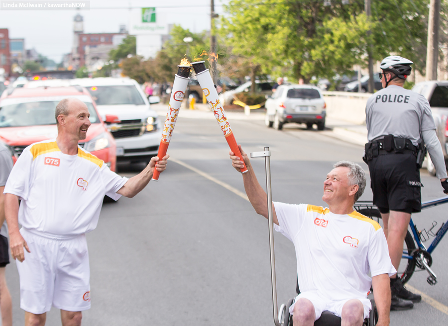 The flame is passed to the final torchbearer, Warsaw athlete Alec Denys