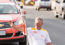 Warsaw Paralympian archer Alec Denys was the final torchbearer and carried the flame into Del Crary Park to light the community cauldron