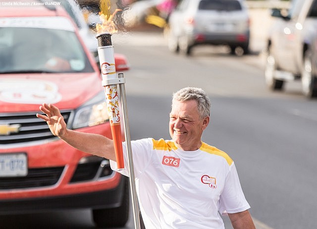 Warsaw Paralympian archer Alec Denys was the final torchbearer and carried the flame into Del Crary Park to light the community cauldron (Photo: Linda McIlwain / kawarthaNOW)