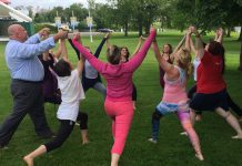 Jim Russell, CEO United Way Peterborough & District, joins in a group pose at Del Crary Park during the June 16th media launch for the Peterborough Yoga Festival, which takes place at the park on Sunday, June 21st