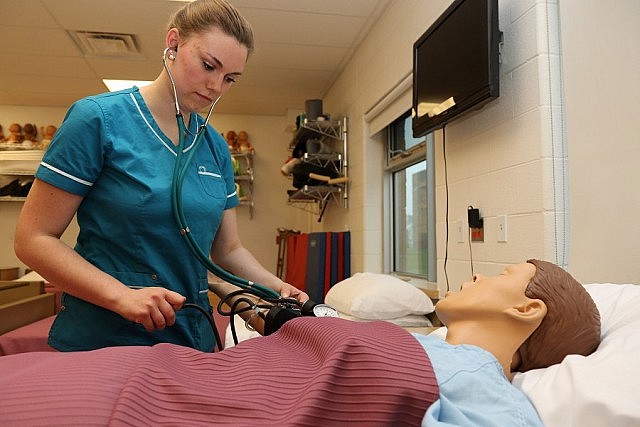 Student Cassie Peeters takes the blood pressure of a simulated patient