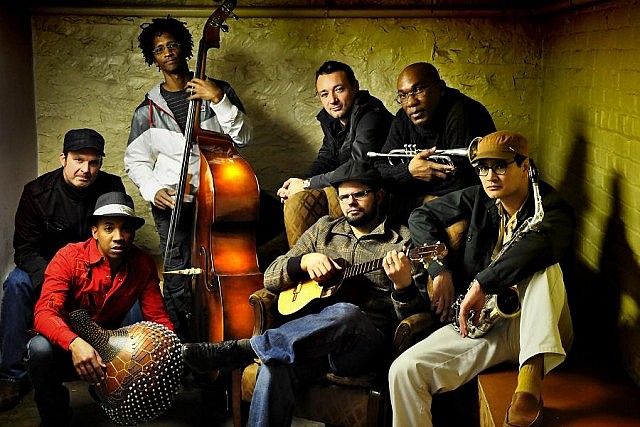 Led by singer-songwriter Drew Gonsalves (seated with guitar), Kobo Town blends calypso with a diverse mix of Caribbean and other musical styles