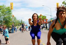 A woman practices yoga on the street at Open Streets in Thunder Bay. Peterborough's first open streets events, Peterborough Pulse, kicks off at 9 a.m. on July 18. Peterborough will open up selected city streets to a variety of fun activities and events, creating a vibrate, playful, and active car-free corridor between Peterborough's downtown and the Saturday Farmers' Market. (Photo: CNW Group/Open Streets Toronto)