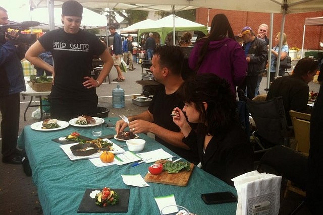 The 3rd Annual Iron Chef Challenge takes place on September 16. At last year's competition, Lindsey Dupuis from Brio Gusto waits to have her dish sampled by Pete Dalliday and Catherine Hanrahan, two of the judges at last year's challenge. (Photo courtesy Peterborough Downtown Farmers' Market.)