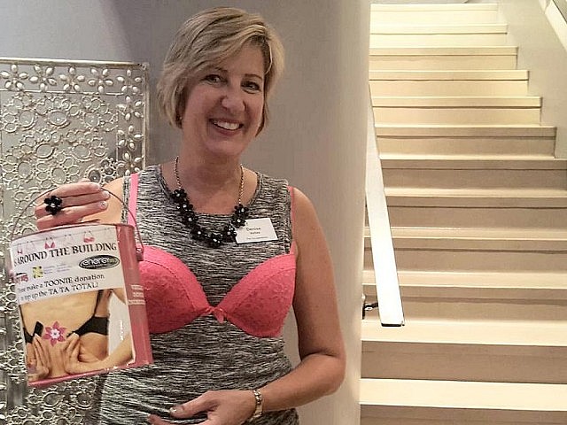 Organizer Denise Vallee (owner of Denise Vallee & Associates Inc. - The Co-operators) collecting toonies for Bras Around the Building at a recent meeting of the Women in Business Network in Peterborough. As well as bras, the campaign welcomes financial donations. (Photo: Jeannine Taylor)