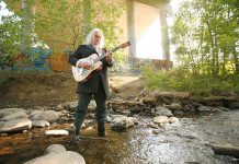 Local songwriter and musician Dennis O'Toole participating in "Going Down to Jackson", a project by Esther Vincent featuring photos of people from all over Peterborough wearing rubber boots and standing in Jackson Creek. The photos will be presented as an outdoor slideshow projection in downtown Peterborough during Artsweek from September 18 to 27. (Photo: Esther Vincent, www.evmustang.ca)