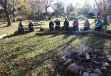 GreenUP Ecology Park volunteers gather around the campfire sharing memories from the gardening season and a hot cup of coffee.