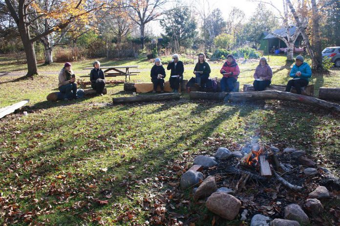 GreenUP Ecology Park volunteers gather around the campfire sharing memories from the gardening season and a hot cup of coffee.