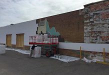 A mural by late Peterborough artist Chris MacGee at the former Craftworks building being covered over with building materials
