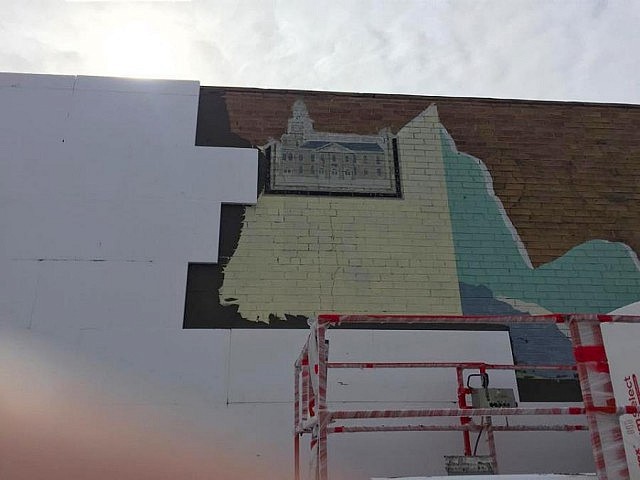 Another view of the mural as it is being covered over
