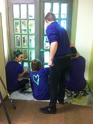 The TELUS Care-A-Van team paints the entranceway to the GreenUP office reception area