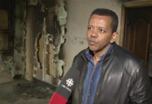 Kenzu Abdella, president of the Kawartha Muslim Religious Association, being interviewed by CBC Television as he surveys the fire and smoke damage to the mosque (photo: CBC Television)