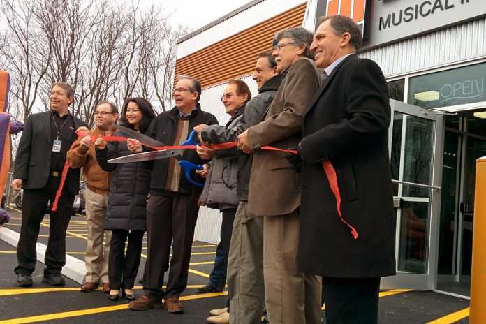 Cutting the ribbon at the official opening of Peterborough's new Long & McQuade store (from left to right): CEO & President Steve Long, councillor Keith Riel, MP Maryam Monsef, MPP Jeaf Leal, Bud Monahan, unidentified, Warden J. Murray Jones, councillor Dave Haacke