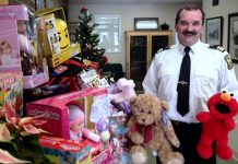 Chief training officer David Braun of Peterborough Fire Services with toys already donated. The firefighters are also giving $1,700 to The Toy Shop, which through the efforts of owner Jean Grant will translate into $3,000 worth of toys (Photo courtesy of Peterborough Fire Services)