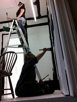 Co-curators Paolo Fortin and Ann Jaeger paint it black to prepare for William Joel Davenport's show at Evans Contemporary in Peterborough (photo: Elizabeth Fennell)