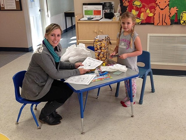 Health Unit Nurse Cassandra Johnston presents prizes to five-year-old Merissa Hansey of Brighton