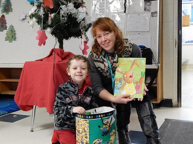 Health Unit Nurse Kelly Holmes presents a prize package to four-year-old Spencer Keppie of Omemee