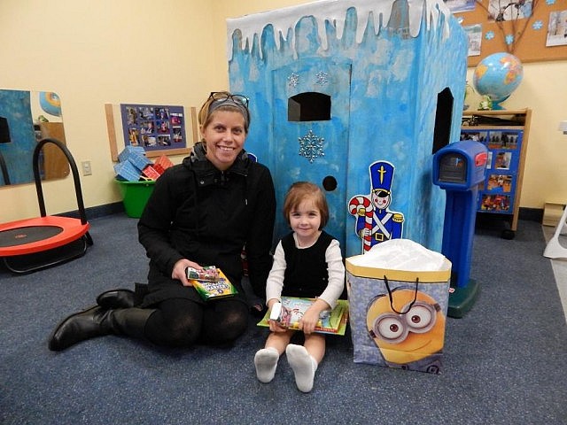 Health Unit Nurse Lori Mosienko presents a prize package to three-year-old Sarah Moyer of Burnt River