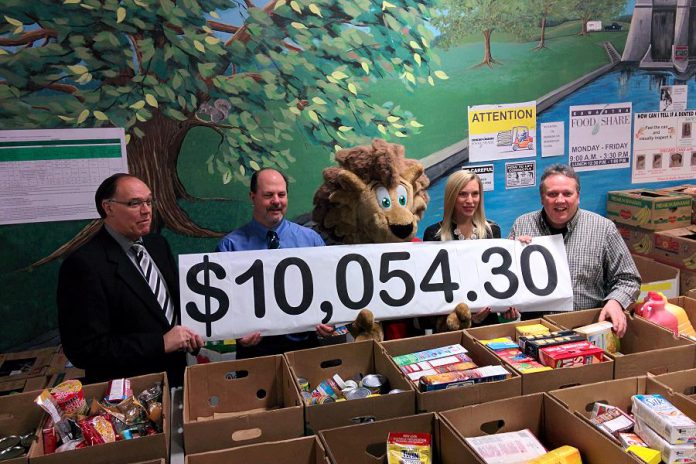 Ashlee Aitken of Kawartha Food Share (second from right) accepts the $10,054.30 donation from (left to right) Peterborough Mayor Daryl Bennett, the City of Peterborough's Manager of Transportation Kevin Jones, DBIA mascot George King of Downtown, and DBIA Executive Director Terry Guiel (photo courtesy Peterborough DBIA)