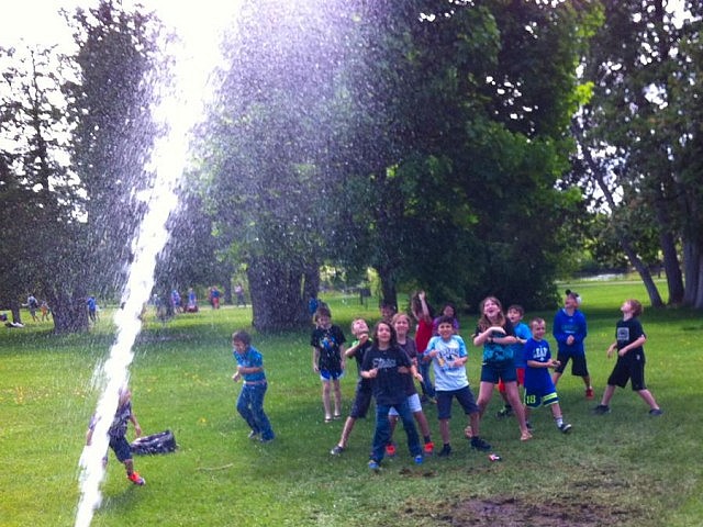 Children enjoy a splash of water after learning how water hydrants work at the Tapping The Source activity centre, led by Peterborough Utilities staff