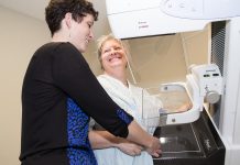 Jill Cummings, Senior Mammography Technologist at PRHC's Breast Assessment Centre, explains how a mammography machine works to writer Jeanne Pengelly