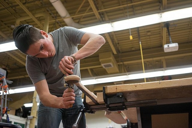 15-year-old student William Miller, who spoke at the Silver Canoe Dinner on February 19, working on his paddle at the January workshop (photo: JT Austin / Sony Canada)