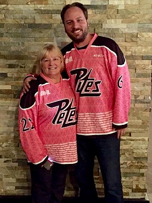 Anne Arnold with Bill Porter, Courtney's boyfriend, at Riley's wearing their commemorative 2016 Pink in the Rink jerseys (photo courtesy of Anne Arnold)