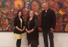 Peterborough-Kawartha MP Maryam Monsef, Art Gallery of Peterborough director Celeste Scopelites, and curator William Kingfisher in front of "The Beauty of Our People" by local artist Arthur Shilling (photo: Art Gallery of Peterborough)