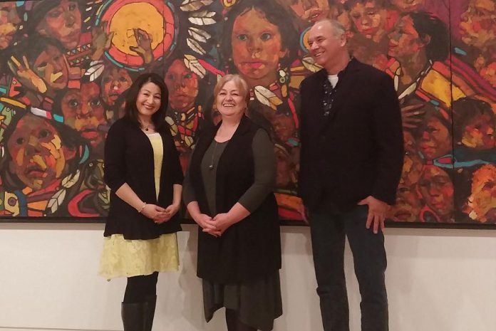 Peterborough-Kawartha MP Maryam Monsef, Art Gallery of Peterborough director Celeste Scopelites, and curator William Kingfisher in front of "The Beauty of Our People" by local artist Arthur Shilling (photo: Art Gallery of Peterborough)