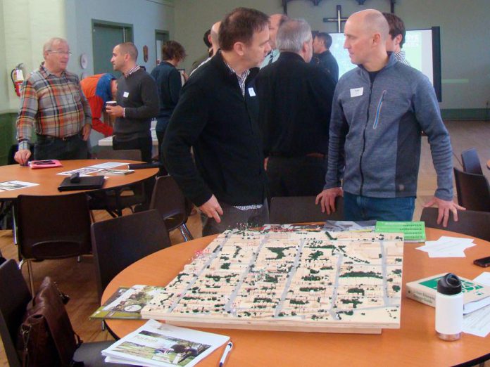 At a design charette for the Active Neighbourhoods Canada Peterborough Project last November, community members, local stakeholders, and City of Peterborough representatives discussed the Bethune Street redevelopment. On the table is the Stewart Street neighbourhood model which community members used to identify places they love, play, travel, and live. (Photo: Karen Halley, GreenUP)