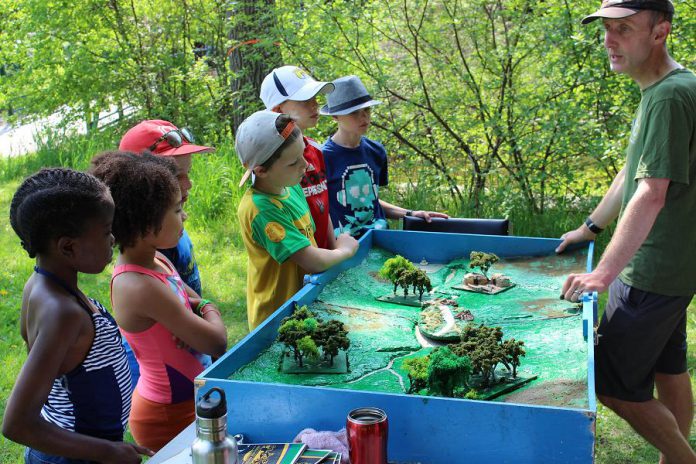 At the Peterborough Children's Water Festival this week, Glen Caradus led students through the history of the Otonabee River from a cultural and environmental perspective by following the story of the river while children interact with a watershed model and find ways to conserve and restore the river (photo: Karen Halley, GreenUp)
