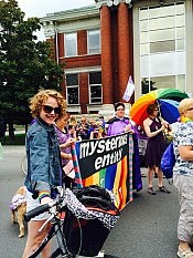 Sarah McNeilly and Em Glasspool (holding banner) and Kate Story (holding umbrella) are board members of Mysterious Entity (photo courtesy of Jill Walker)