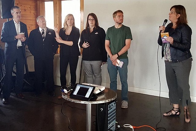 Tracey Randall, general manager of Peterborough Musicfest, announcing the 30th anniversary season line-up at the boathouse at Millennium Park in Peterborough as staff and festival board members look on (photo: Jeannine Taylor / kawarthaNOW)