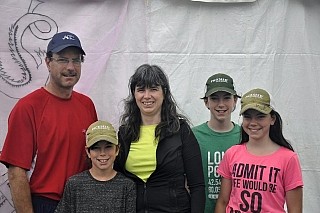 Nora Darling (middle) races because she knows how breast cancer affects families: her sister had breast cancer. "We always come to this event," she says. And now it's a family affair -- with her children volunteering in support of the cause.
